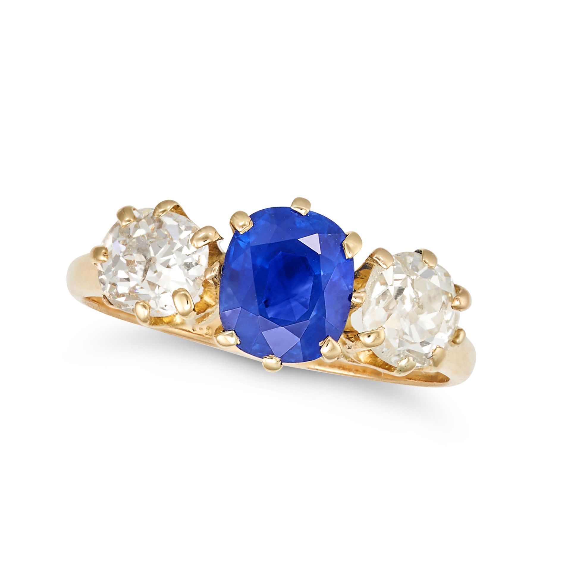 AN UNHEATED KASHMIR SAPPHIRE AND DIAMOND THREE STONE RING in yellow gold, set with a cushion cut ...