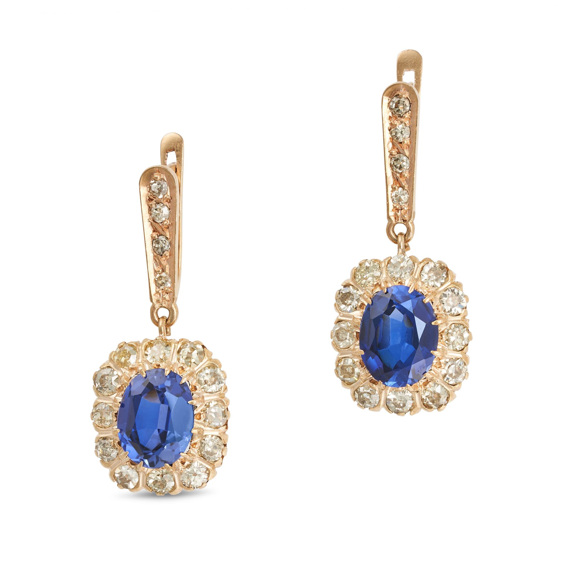 A PAIR OF SYNTHETIC SAPPHIRE AND DIAMOND DROP EARRINGS in yellow gold, each set with a row of sin...