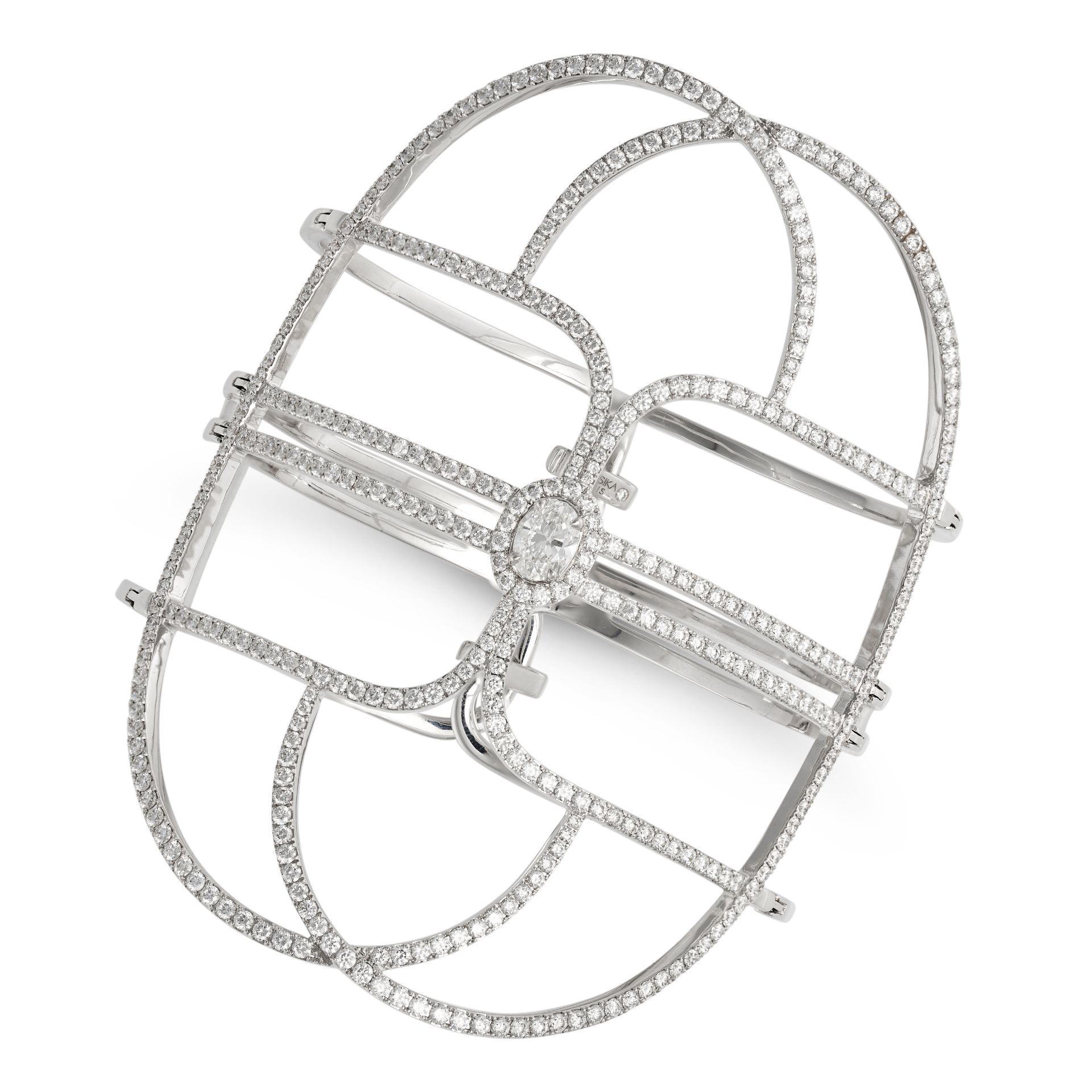 MESSIKA, A GLAM'AZONE DIAMOND CUFF BRACELET in 18ct white gold, set with an oval cut diamond of a...