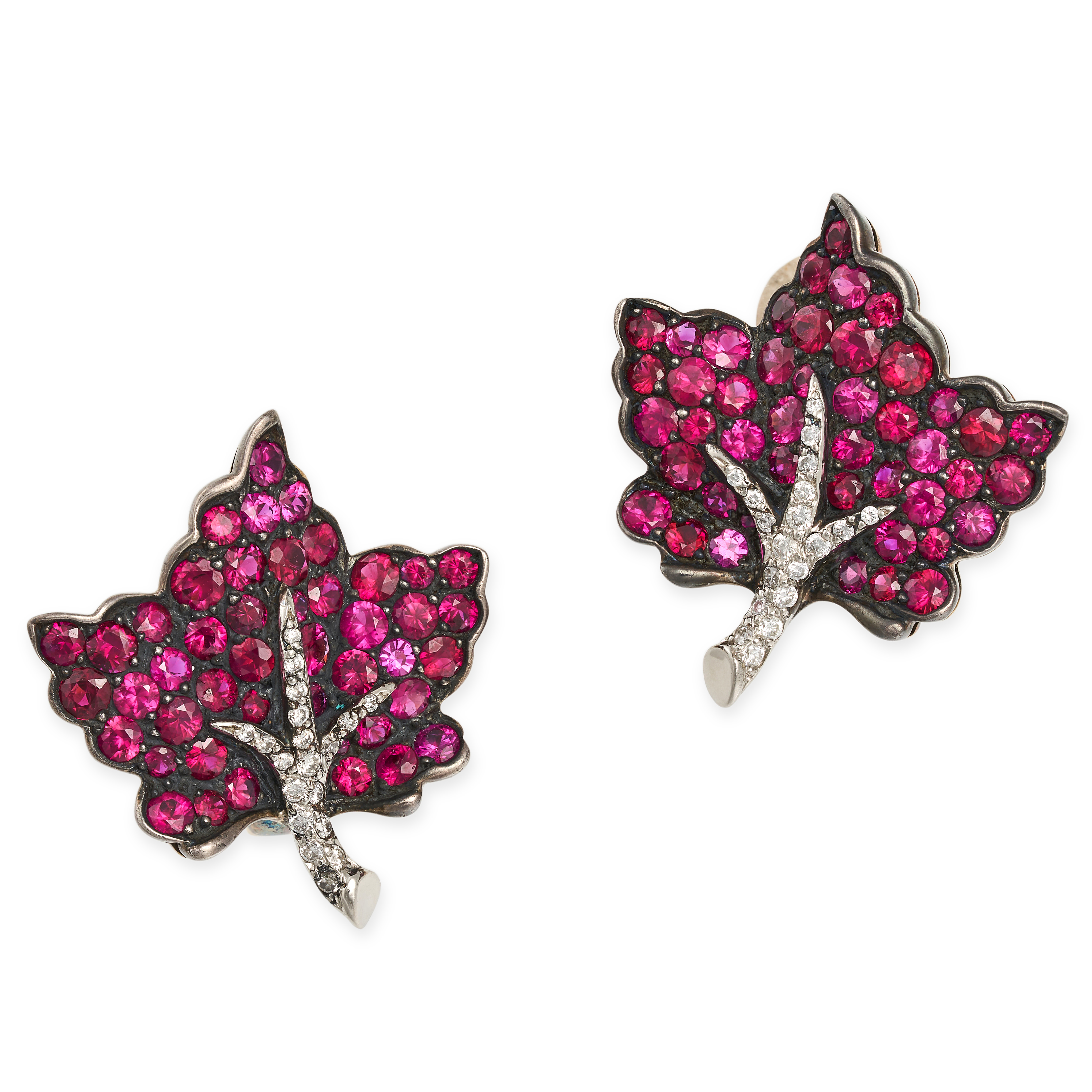 A PAIR OF RUBY AND DIAMOND LEAF EARRINGS in 18ct yellow and blackened gold, each designed as a le...