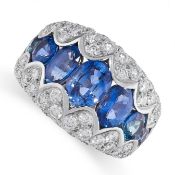 A SAPPHIRE AND DIAMOND DRESS RING in 18ct white gold, the tapering band set with a row of graduat...