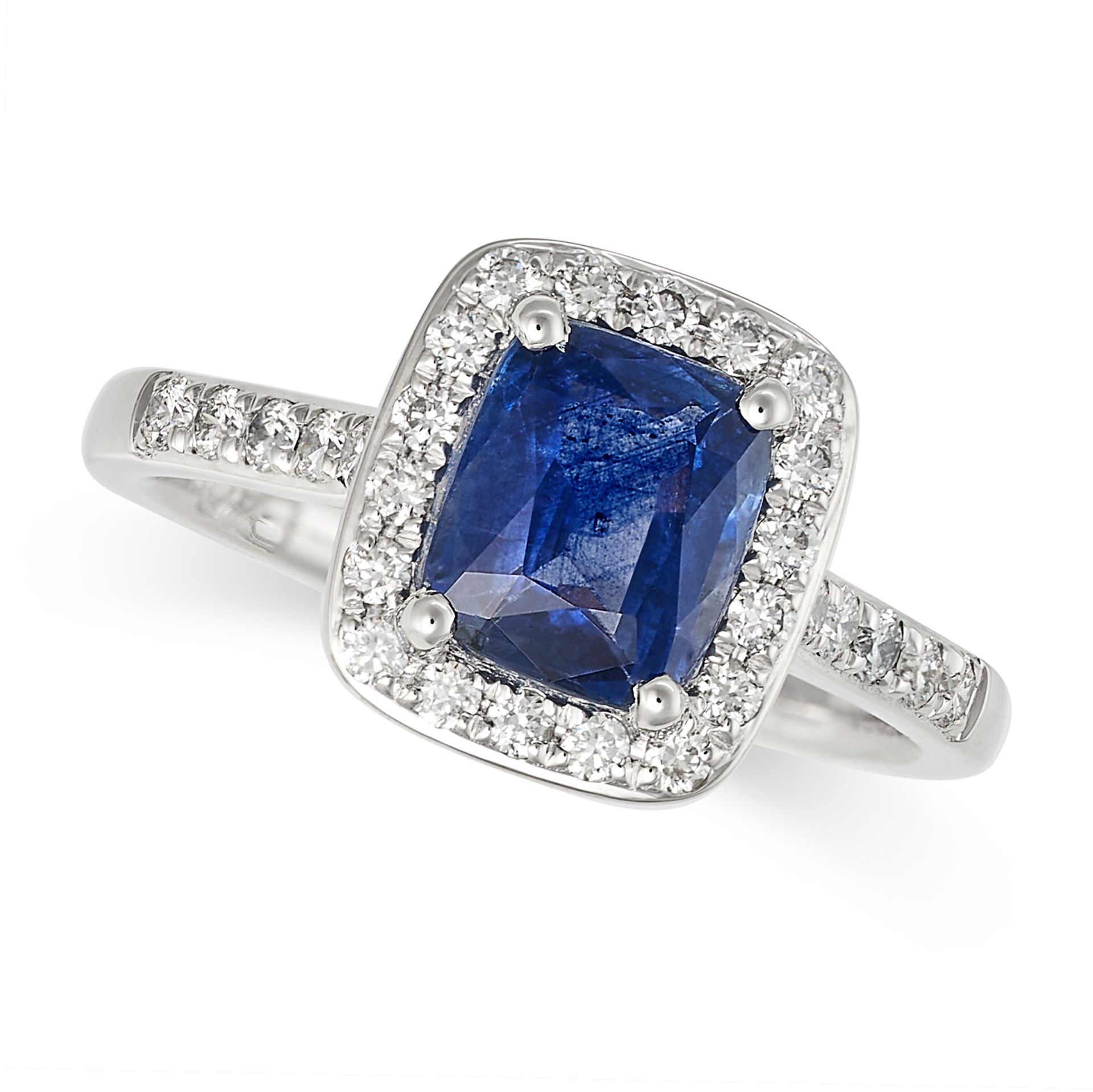 A SAPPHIRE AND DIAMOND CLUSTER RING in platinum, set with a cushion cut sapphire of 2.03 carats i...