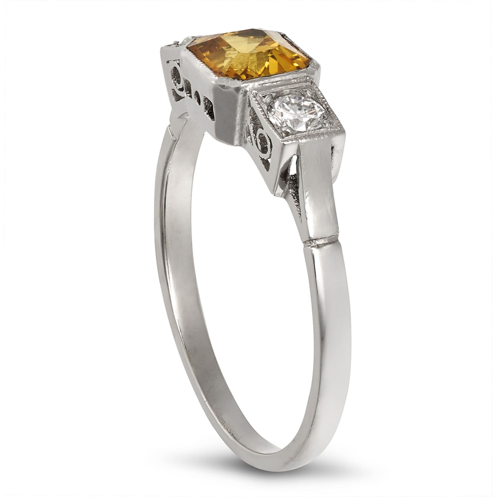 A YELLOW SAPPHIRE AND DIAMOND THREE STONE RING in platinum, set with an octagonal step cut yellow... - Image 2 of 2