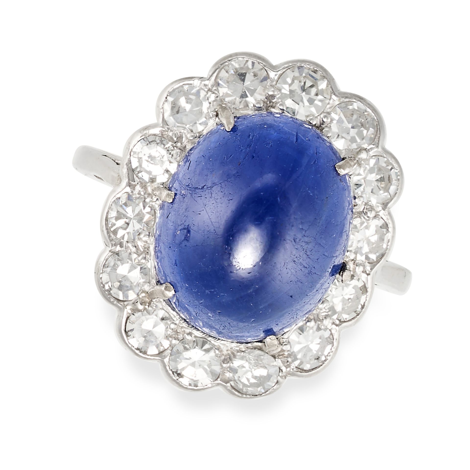 NO RESERVE - A SAPPHIRE AND DIAMOND CLUSTER RING set with a cabochon sapphire of approximately 5....