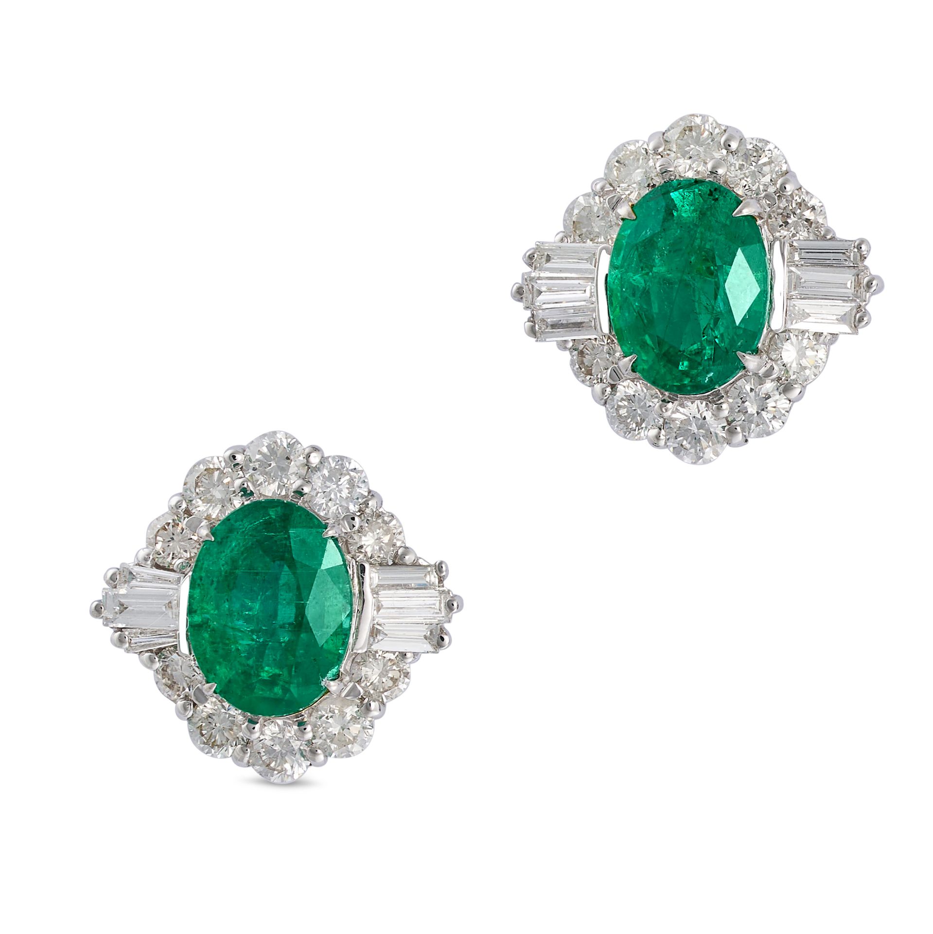 A PAIR OF EMERALD AND DIAMOND STUD EARRINGS in 18ct white gold, each set with an oval cut emerald...