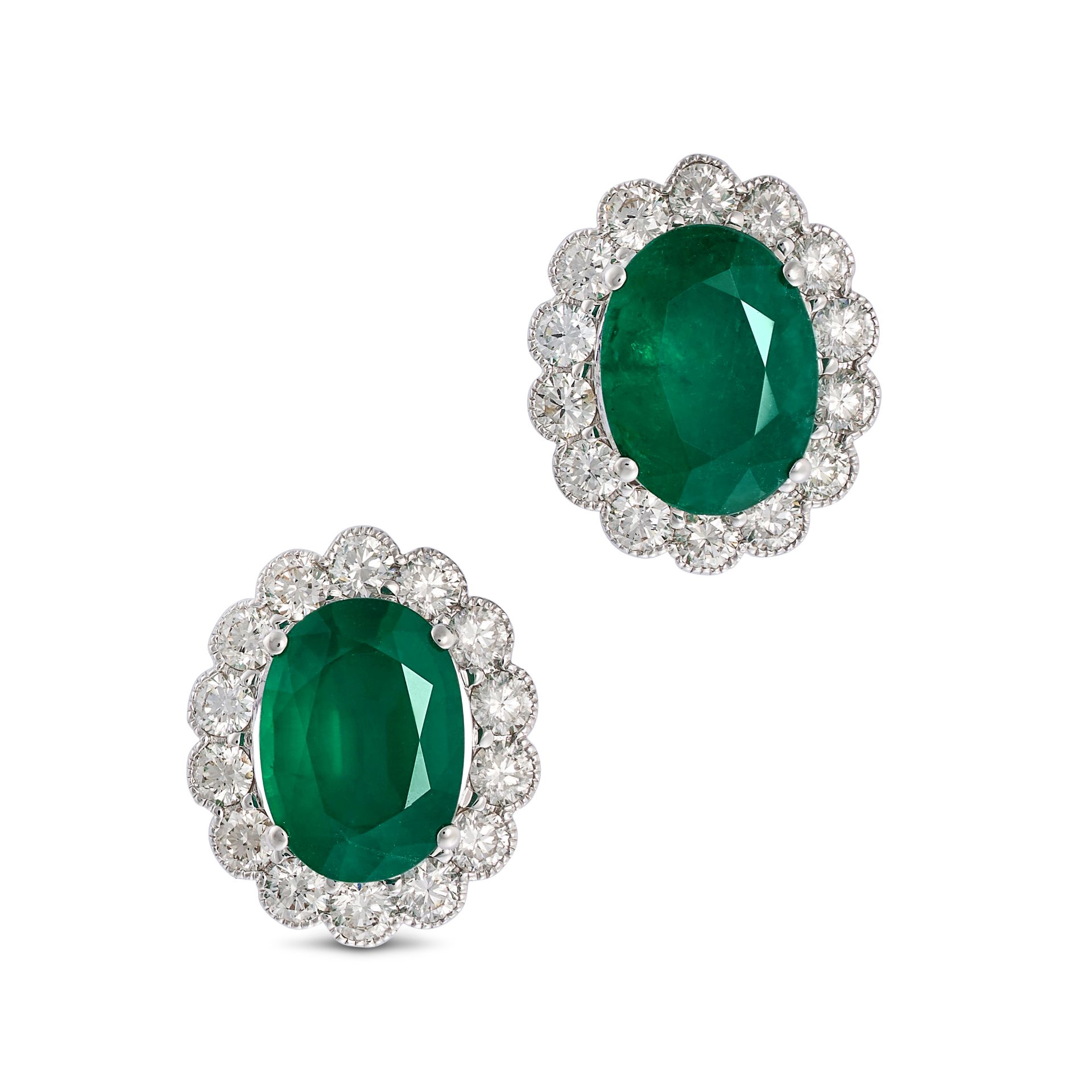 A PAIR OF EMERALD AND DIAMOND CLUSTER EARRINGS in 18ct white gold, each set with an oval cut emer...