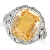 A YELLOW SAPPHIRE AND DIAMOND DRESS RING set with a cushion cut yellow sapphire of approximately ...