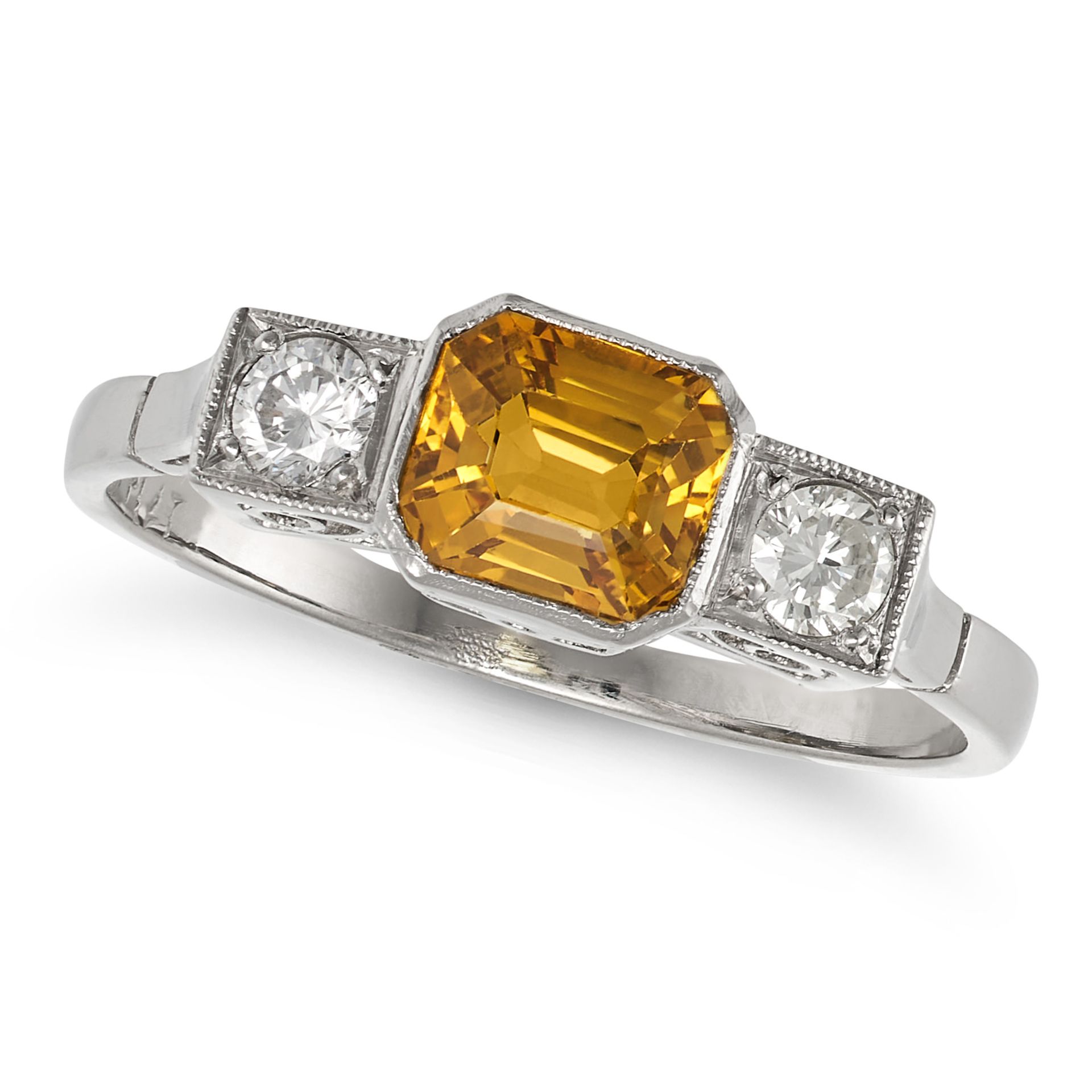 A YELLOW SAPPHIRE AND DIAMOND THREE STONE RING in platinum, set with an octagonal step cut yellow...