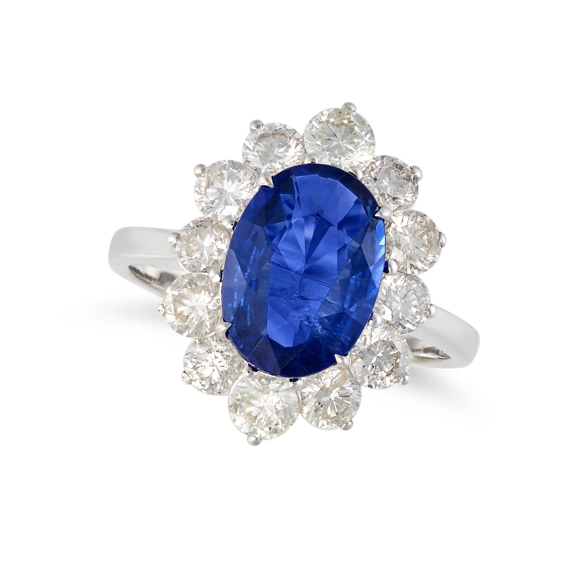 A SAPPHIRE AND DIAMOND CLUSTER RING in 18ct white gold, set with an oval cut sapphire of 2.87 car...