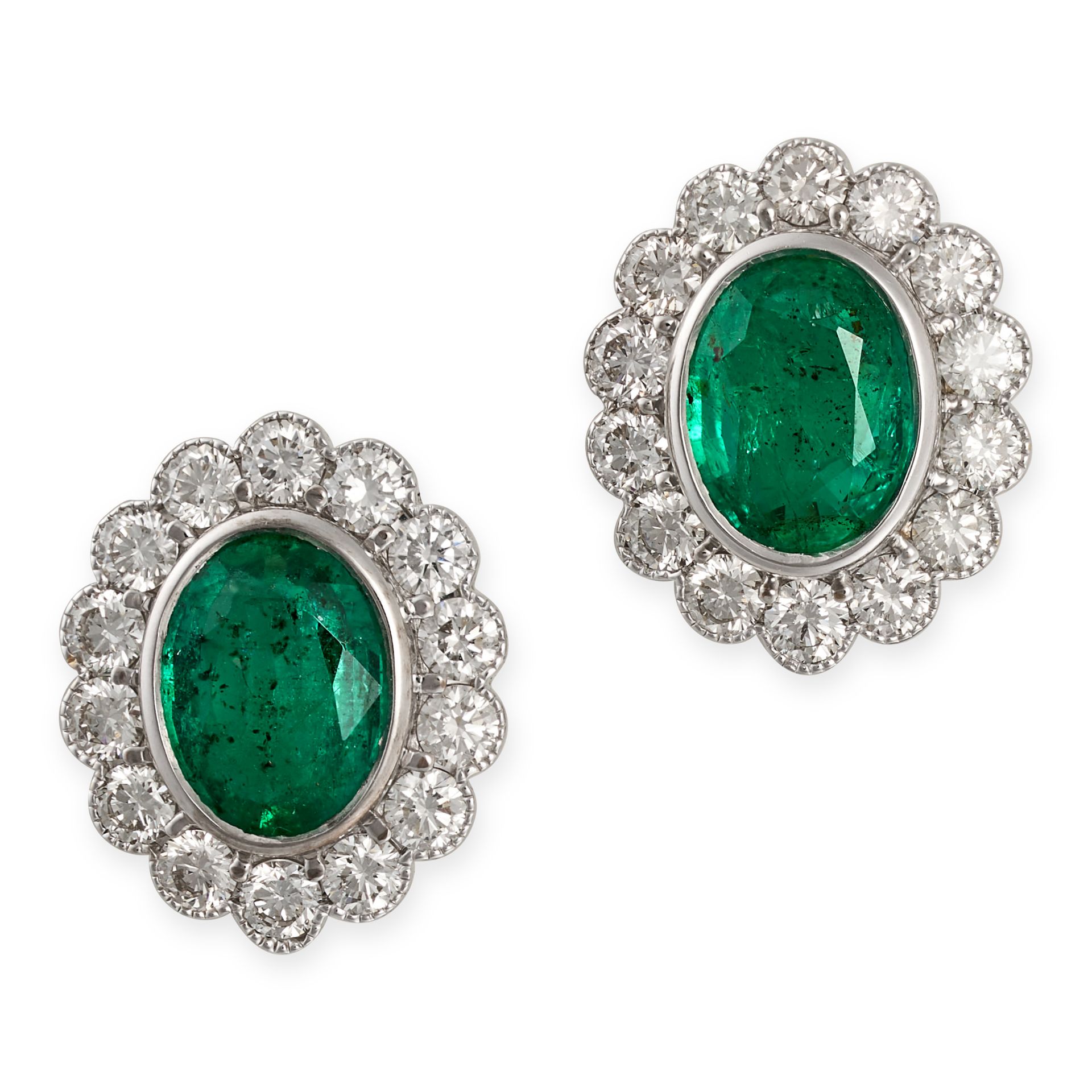 A PAIR OF EMERALD AND DIAMOND CLUSTER EARRINGS in white gold, each set with an oval cut emerald i...