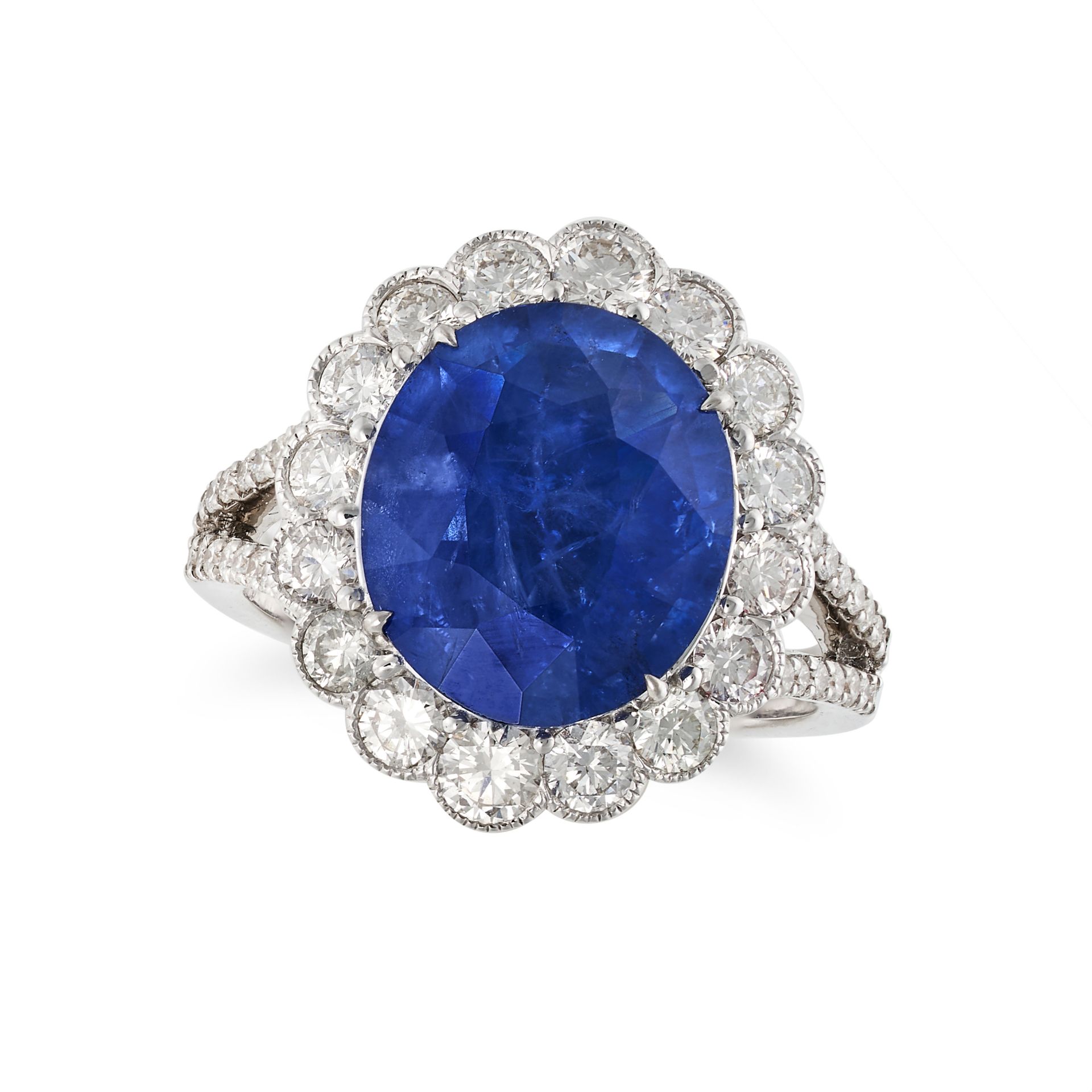 A SAPPHIRE AND DIAMOND CLUSTER RING in 18ct white gold, set with an oval cut sapphire of 5.72 car...