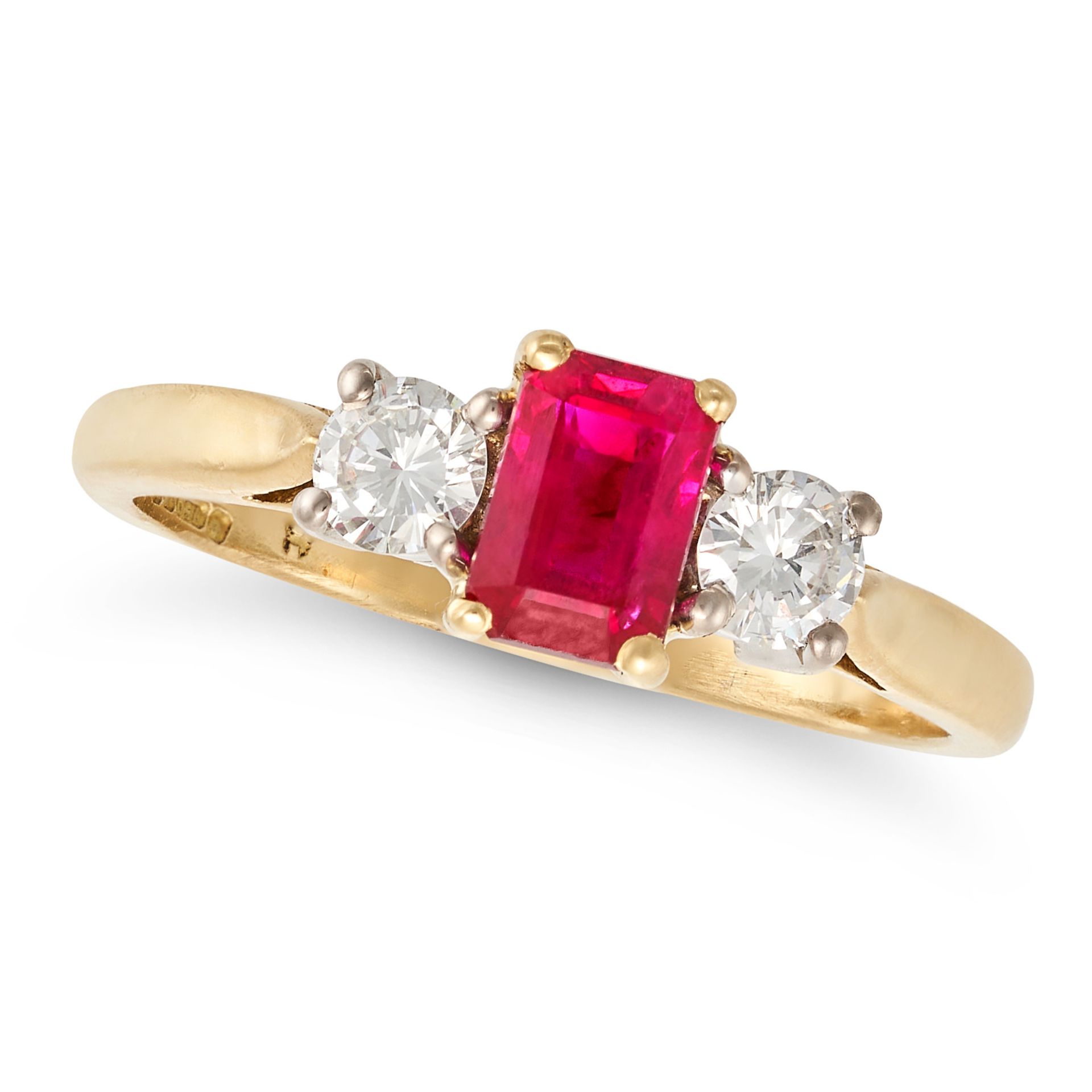 A RUBY AND DIAMOND THREE STONE RING in 18ct yellow gold, set with a rectangular step cut ruby bet...