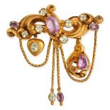 AN ANTIQUE PINK TOPAZ AND CHRYSOLITE BROOCH in yellow gold, the scrolling body set with oval cut ...