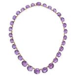 AN AMETHYST RIVIERE NECKLACE in yellow gold, comprising a row of graduated oval cut amethysts, 40...
