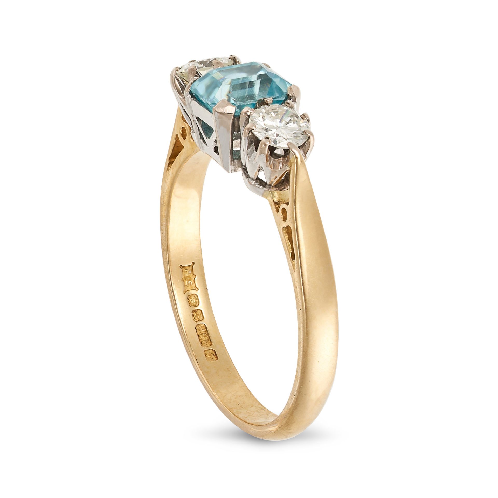 A BLUE ZIRCON AND DIAMOND THREE STONE RING in 18ct yellow gold, set with an octagonal mixed cut b... - Bild 2 aus 2
