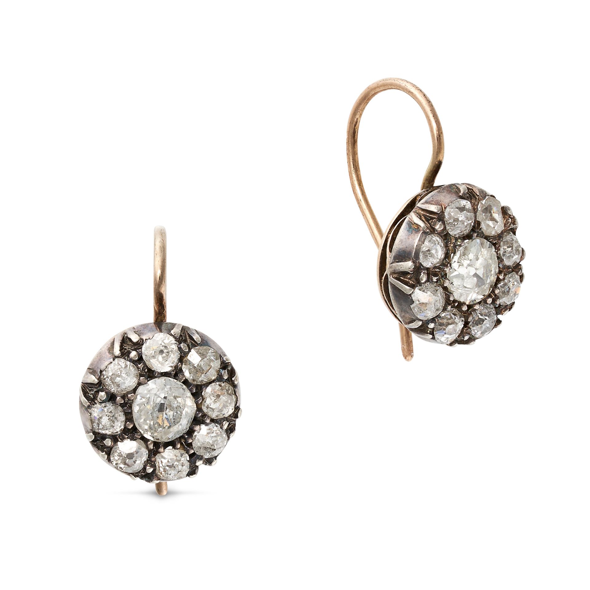 A PAIR OF ANTIQUE DIAMOND CLUSTER EARRINGS in yellow gold and silver, each set with an old cut di...