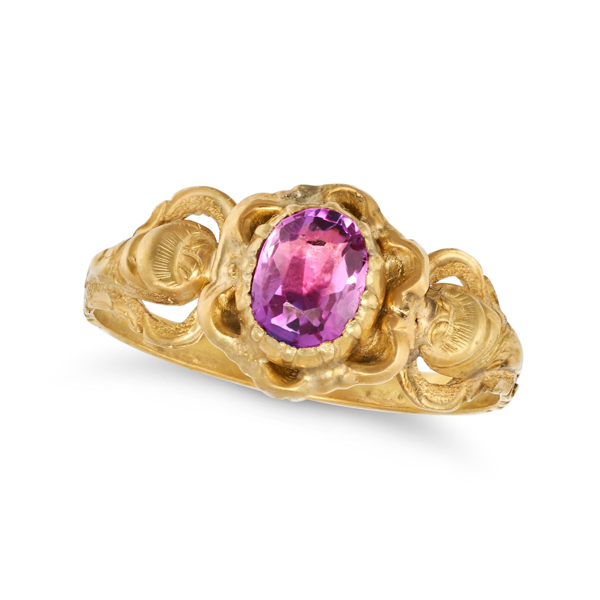 AN ANTIQUE PINK SAPPHIRE RING in yellow gold, the ornate band set with an oval cut pink sapphire,...