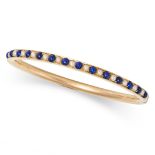 AN ANTIQUE LAPIS LAZULI AND PEARL BANGLE in yellow gold, set with a row of alternating cabochon c...