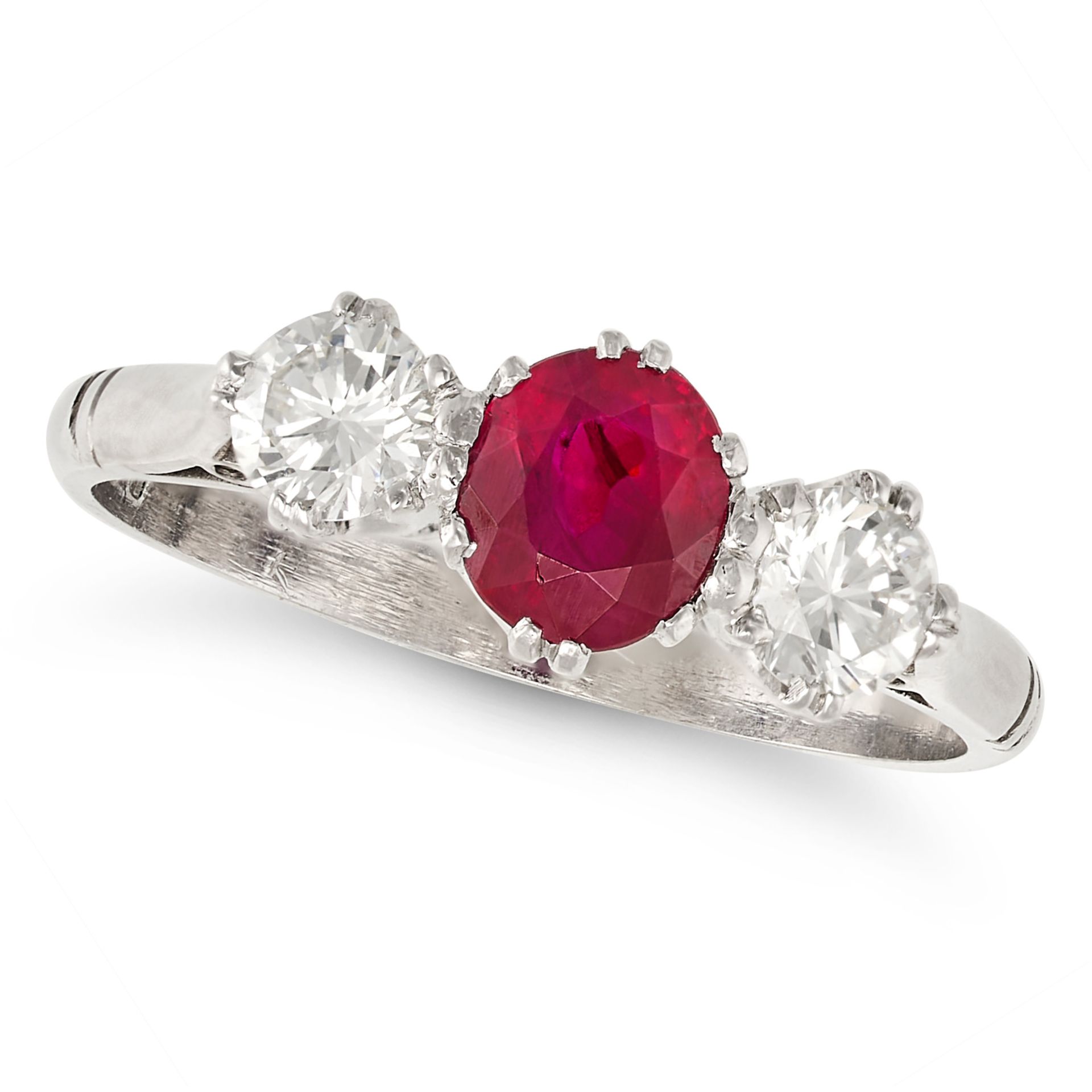 A RUBY AND DIAMOND THREE STONE RING in platinum, set with an oval cut ruby of approximately 1.01 ...