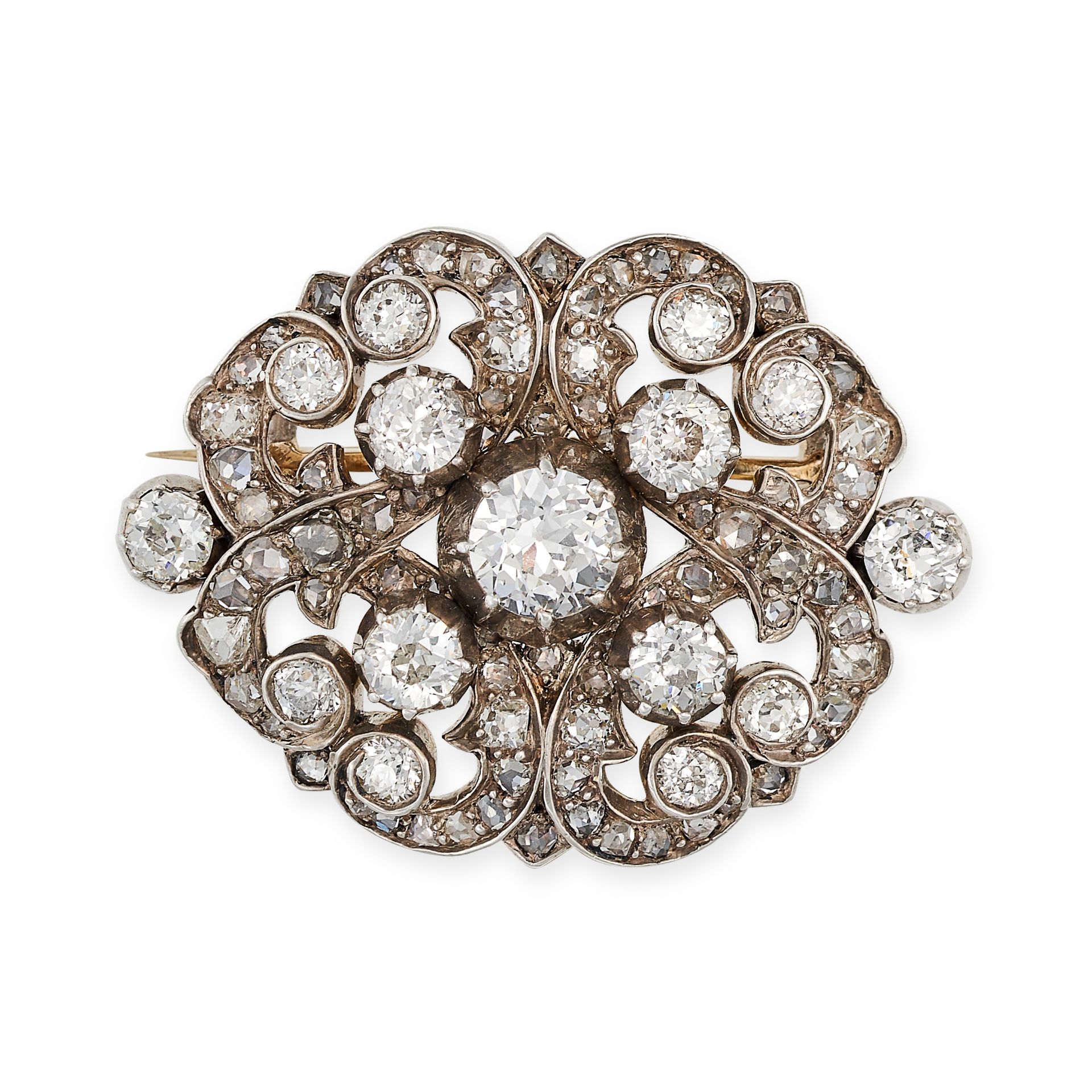 AN ANTIQUE DIAMOND BROOCH in yellow gold and silver, in scrolling form set throughout with old cu...
