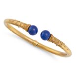 AN ANTIQUE LAPIS LAZULI BANGLE in yellow gold, the open hinged bangle terminating in two polished...