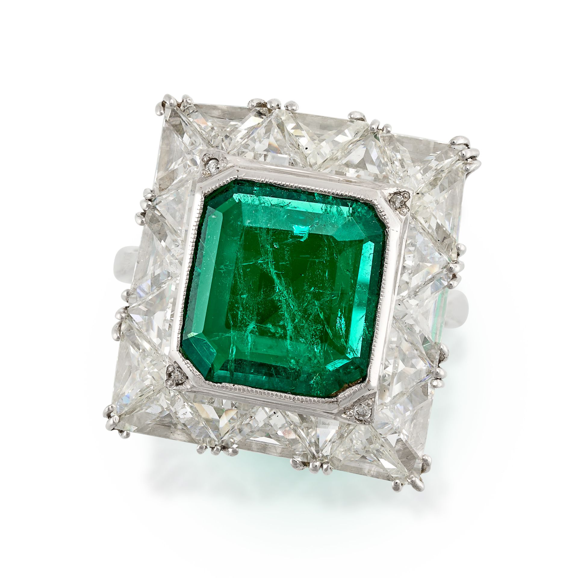 AN EMERALD AND DIAMOND CLUSTER RING in platinum, set with an octagonal step cut emerald of 2.89 c...