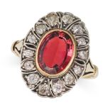 A VINTAGE PINK TOURMALINE AND DIAMOND CLUSTER RING in yellow gold and silver, set with an oval cu...