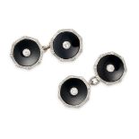 A PAIR OF ONYX AND DIAMOND CUFFLINKS in platinum and 18ct white gold, each face comprising an ony...