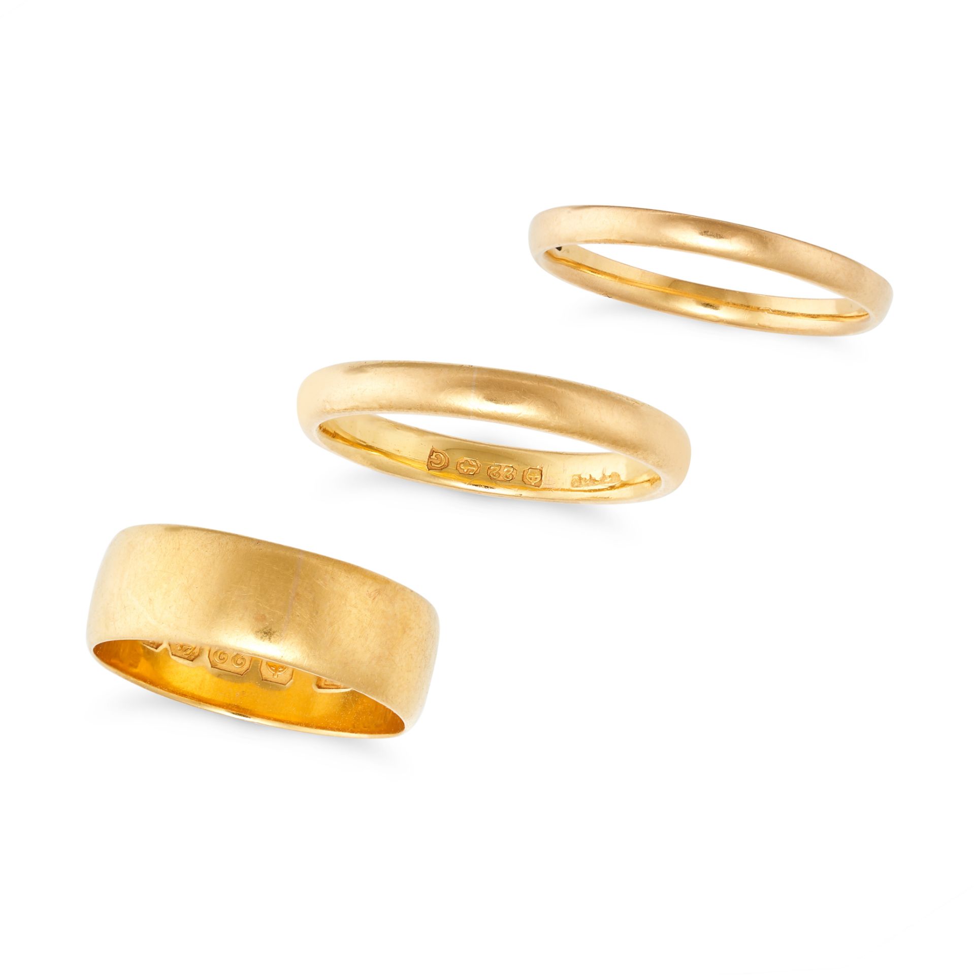 THREE ANTIQUE AND VINTAGE GOLD WEDDING BAND RINGS in 22ct yellow gold, each of plain design, one ...