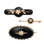 THREE ANTIQUE ONYX AND PEARL BROOCHES one in oval design set with a polished onyx with an applied...