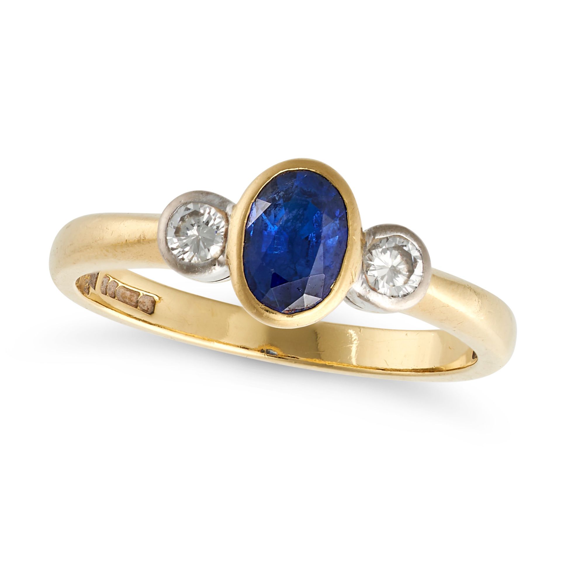 A SAPPHIRE AND DIAMOND THREE STONE RING in 18ct yellow gold, set with an oval cut sapphire accent...
