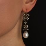 A PAIR OF ANTIQUE PEARL AND DIAMOND DROP EARRINGS in yellow gold and silver, each designed with f...
