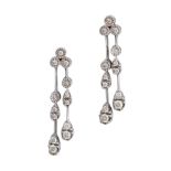 A PAIR OF DIAMOND DROP EARRINGS in 18ct white gold, each set with a trio of round brilliant cut d...