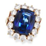 A SYNTHETIC SAPPHIRE AND CUBIC ZIRCONIA CLUSTER RING in 18ct yellow gold, set with a cushion cut ...