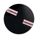 AN ONYX, RUBY AND DIAMOND BROOCH in white gold and platinum, comprising a polished onyx disc set ...