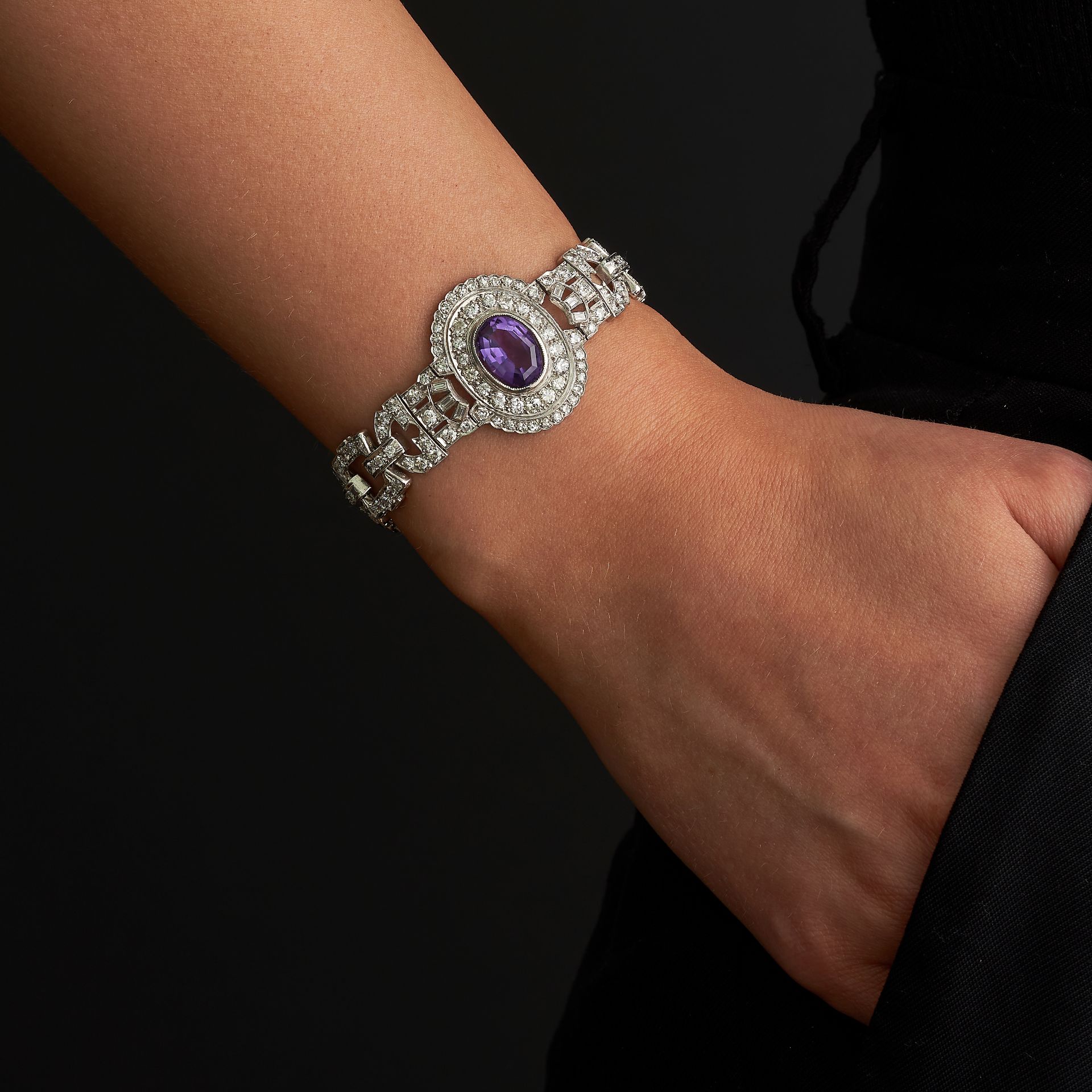 AN AMETHYST AND DIAMOND BRACELET, 1940s in platinum, set with three oval cut amethysts in double ... - Image 2 of 3