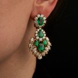 A PAIR OF EMERALD AND DIAMOND DROP EARRINGS in 18ct yellow gold, set with an oval cut emerald in ...