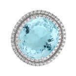 AN IMPORTANT PARAIBA TOURMALINE AND DIAMOND RING in platinum, set with an oval mixed cut Paraiba ...
