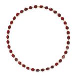 AN ANTIQUE GARNET RIVIERE NECKLACE in yellow gold, set with a row of oval cut garnets, stamped 9K...