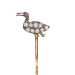 AN ANTIQUE DIAMOND AND RUBY DUCK STICK / TIE PIN BROOCH in yellow gold and silver, designed as a ...