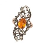 A PASTE DRESS RING in 18ct yellow gold and silver, set with an oval cut orange paste stone in an ...