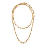 AN ANTIQUE FANCY LINK SAUTOIR NECKLACE in 14ct yellow gold, comprising a row of alternating bifur...