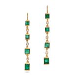 A PAIR OF EMERALD AND DIAMOND DROP EARRINGS in yellow gold, each comprising a row of alternating ...