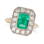 A COLOMBIAN EMERALD AND DIAMOND CLUSTER RING in yellow gold, set with an octagonal step cut emera...