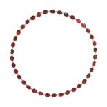 AN ANTIQUE GARNET RIVIERE NECKLACE in yellow gold, comprising a row of oval cut garnets, 42.5cm, ...