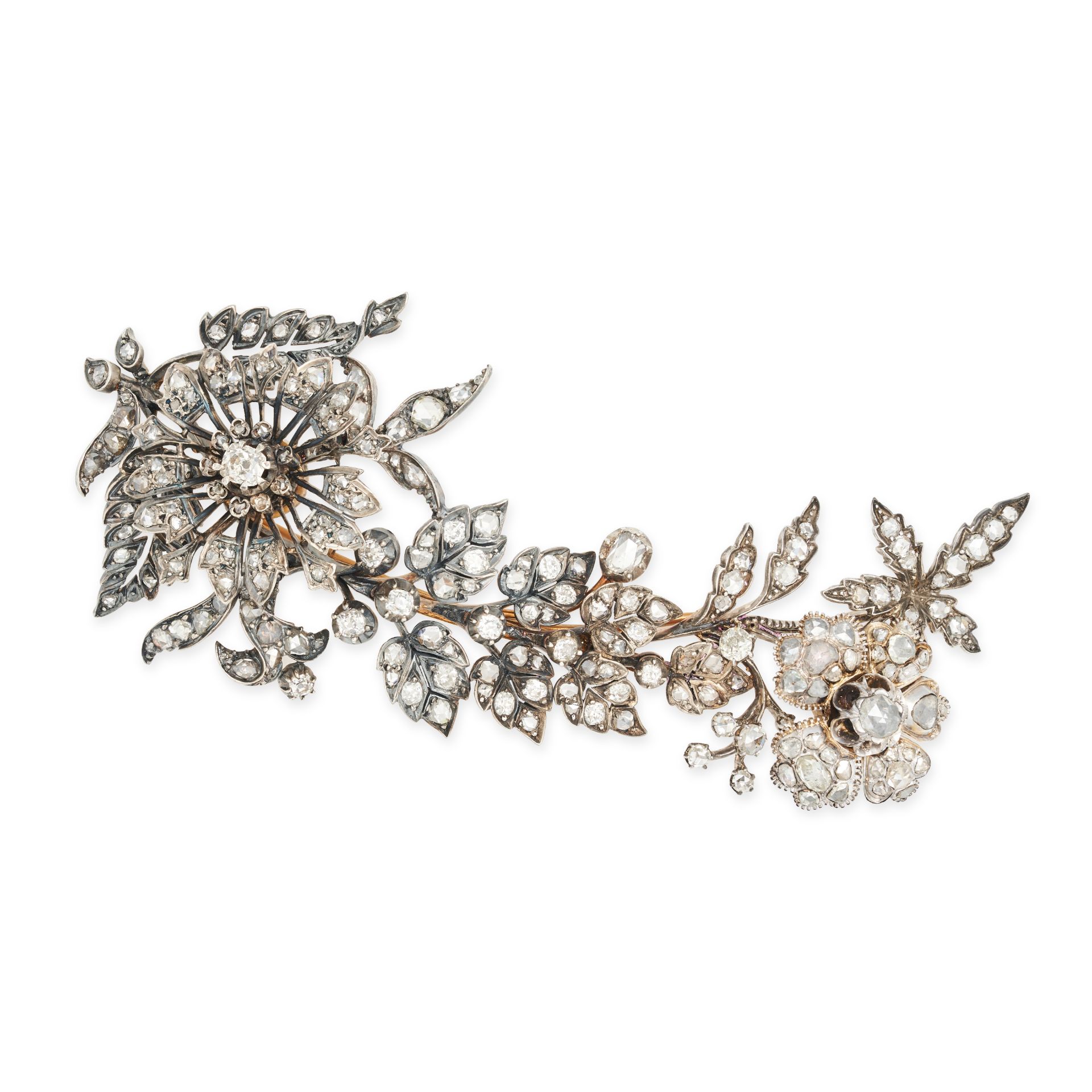 AN ANTIQUE DIAMOND EN TREMBLANT BROOCH in yellow gold and silver, designed as a floral spray set ...