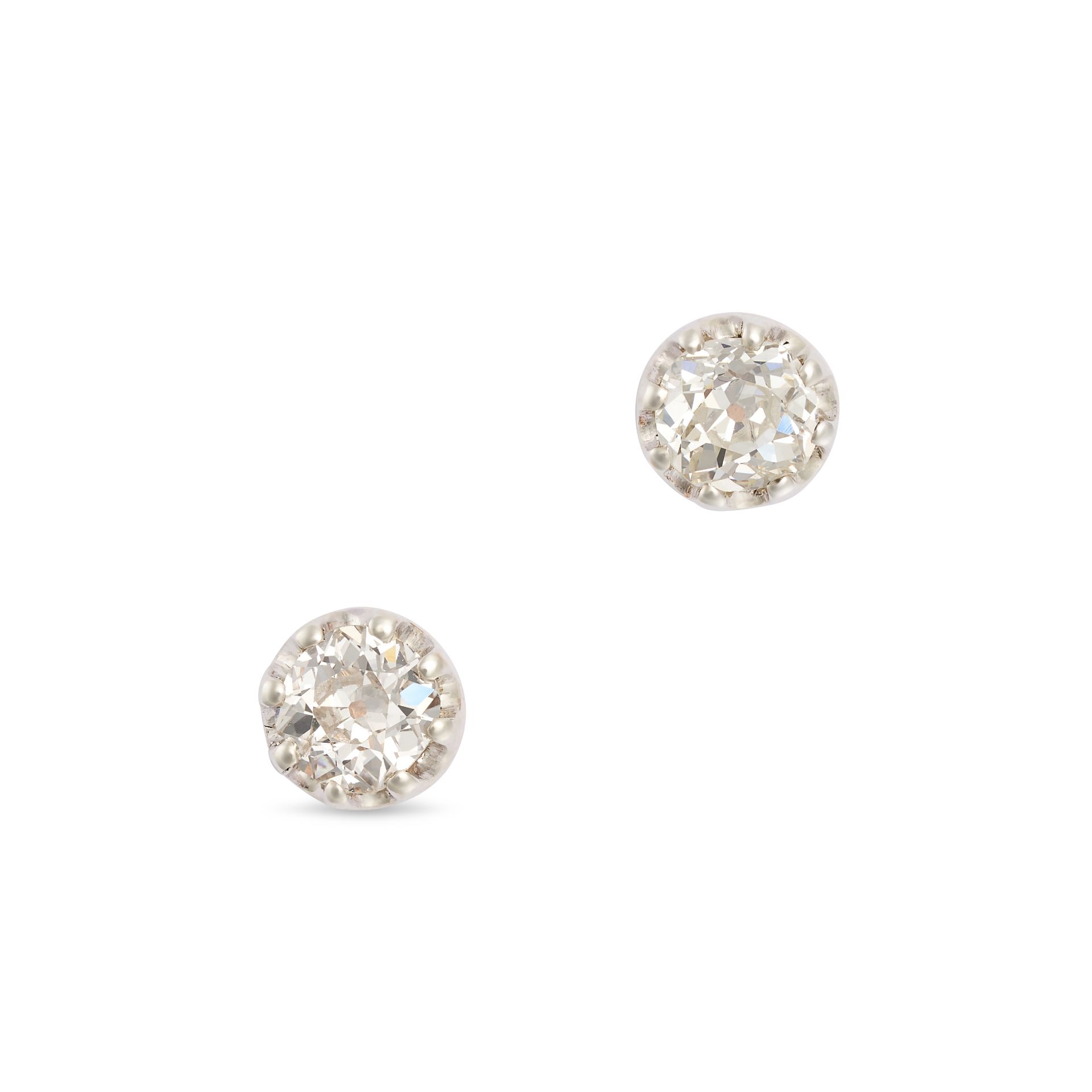 A PAIR OF DIAMOND STUD EARRINGS in yellow and white gold, each set with an old cut diamond of app...