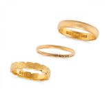 A COLLECTION OF THREE GOLD WEDDING BAND RINGS in 22ct yellow gold, two of plain design and one wi...