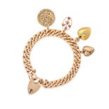 AN ANTIQUE CHARM PADLOCK BRACELET in 15ct and 9ct yellow gold, the curb chain suspending four cha...