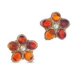 A PAIR OF GARNET AND PEARL FLOWER STUD EARRINGS in yellow gold, each set with a pearl accented by...